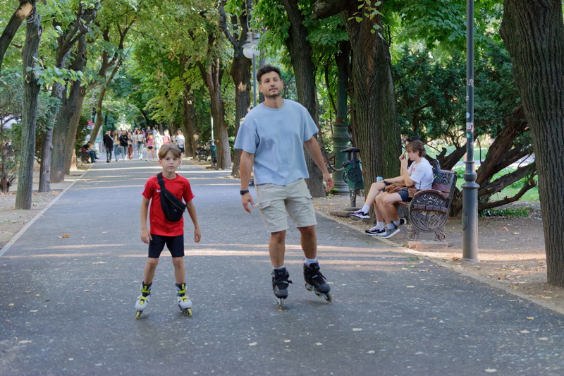 Man and little boy rollerblading